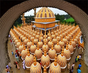 Modern 201 Dome mosque surrounded by greenery in Tangail, Bangladesh.