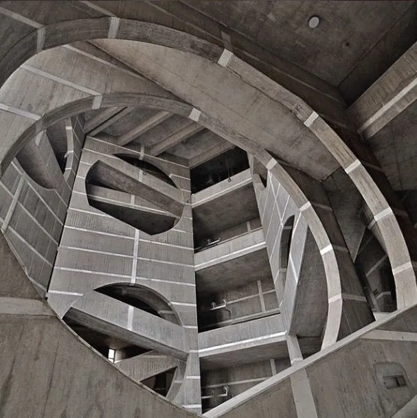 Geometric concrete stairwell inside the National Parliament House, showcasing circular forms and modernist architecture in Dhaka.