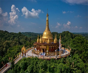 Golden Buddhist temple atop green hills in Bandorban, Chittagong.