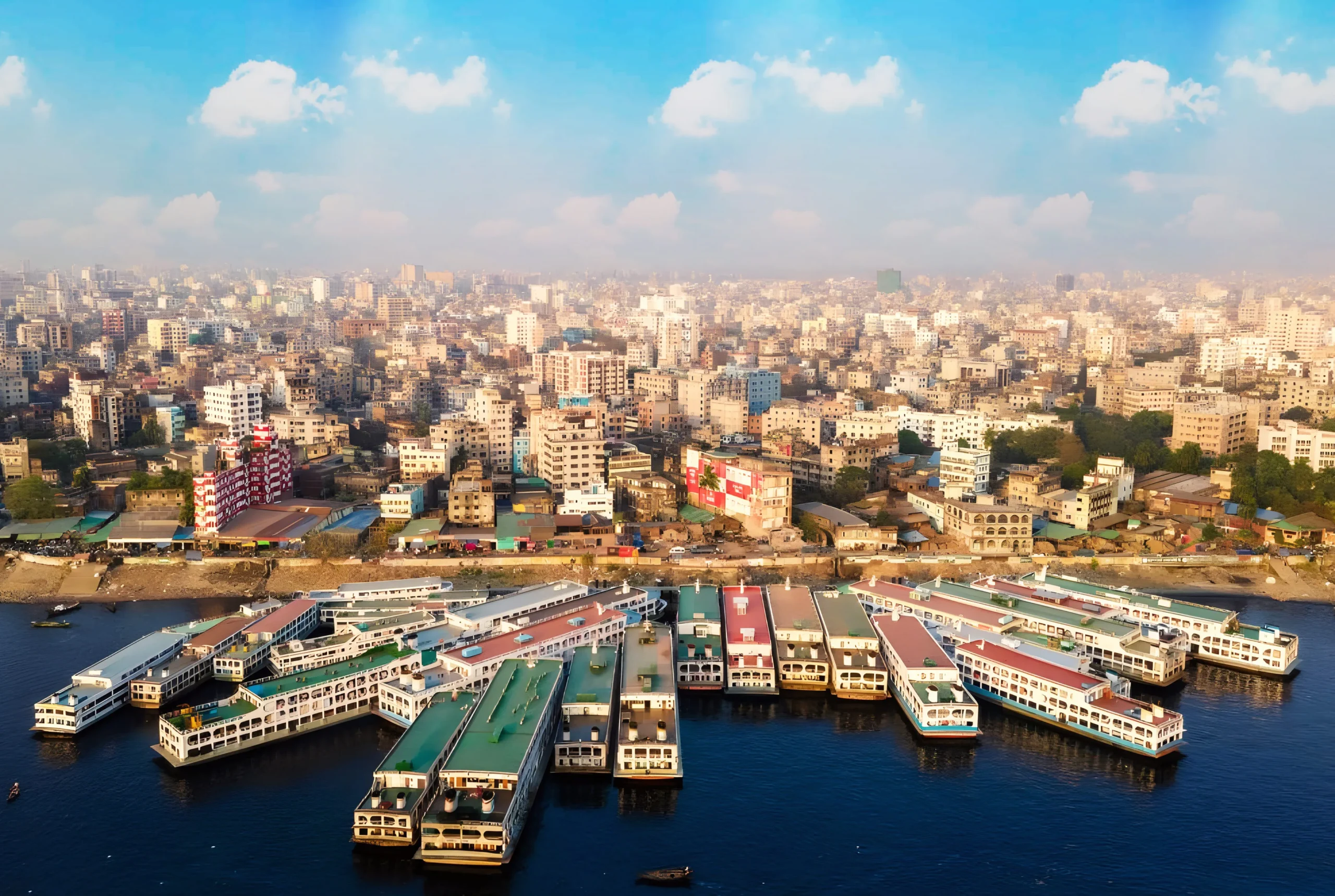 Aerial drone view of large passenger ferry boats docked at Sadarghat Launch Terminal on the Buriganga River in Old Dhaka, Bangladesh.